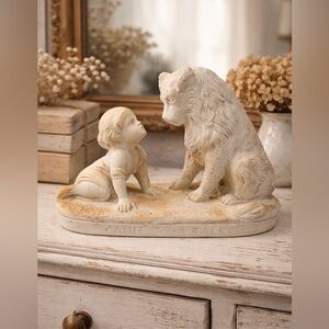 Cream Figurine of Child and Dog. Has a nice Patina. Very Good Condition. G13